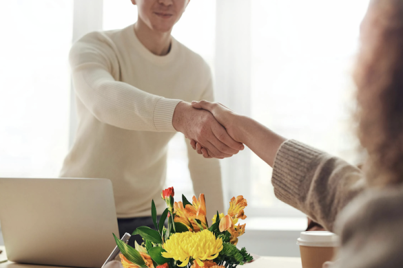 Markzware Partners (partnerships, affiliates, trainers, resellers, distributors), 780x520: Male at Desk with Laptop, Flowers, & Coffee Shakes Hands with Female.